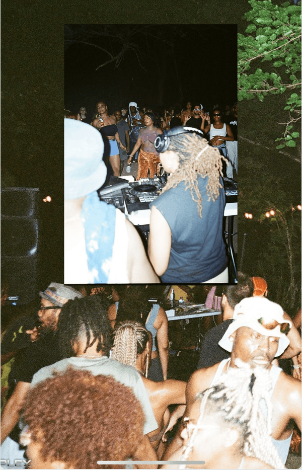 DJ B.A.E. performing outdoors at night